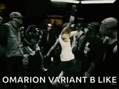 A Group Of People Are Dancing In A Dark Room And A Man Is Standing In The Middle Of The Crowd . GIF