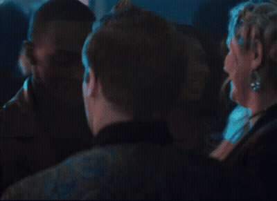 A Group Of People Are Dancing In A Dark Room And One Of Them Is Wearing A Black Jacket GIF