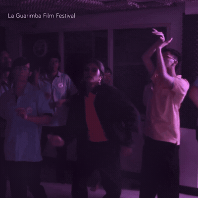 A Group Of People Are Dancing In A Dark Room And The Words La Guarimba Film Festival Are Above Them GIF