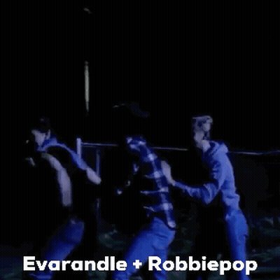 A Group Of People Are Dancing In A Dark Room With The Words Everandle + Robbiepop Written Above Them . GIF