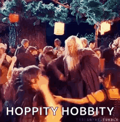 A Group Of People Are Dancing In A Forest With The Words `` Hoppity Hobbity '' Written On The Bottom Of The Image . GIF