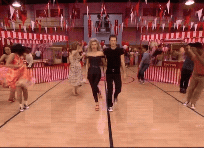 A Group Of People Are Dancing In A Gym With Cotton Candy Stands In The Background GIF