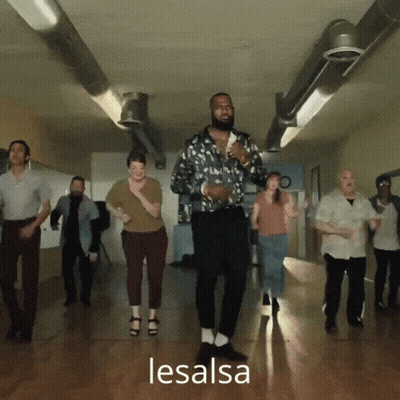 A Group Of People Are Dancing In A Hallway And The Word Lesalsa Is On The Bottom Right GIF
