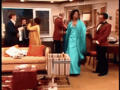 A Group Of People Are Dancing In A Living Room . GIF