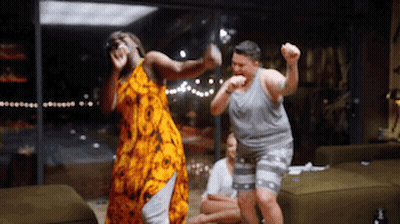 A Group Of People Are Dancing In A Living Room GIF