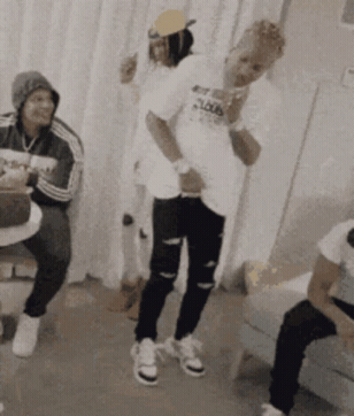 A Group Of People Are Dancing In A Room And One Of Them Is Wearing A Shirt That Says ' Loud ' On It GIF