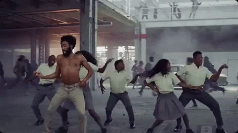 A Group Of People Are Dancing In A Room In A Building . GIF