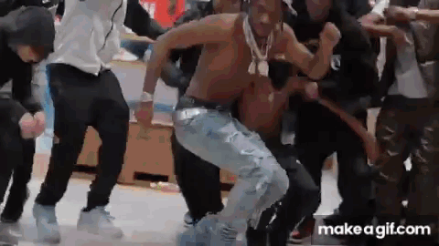A Group Of People Are Dancing In A Room . GIF