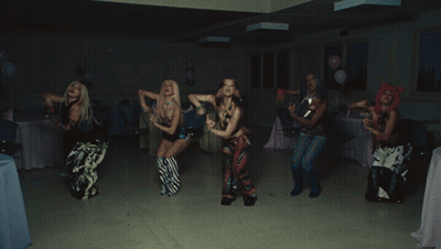 A Group Of People Are Dancing In A Room With A Blue Bag That Says Hawaii GIF