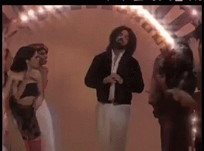 A Group Of People Are Dancing In A Room With A Fire Coming Out Of Their Mouths GIF