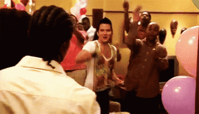 A Group Of People Are Dancing In A Room With Pink Balloons GIF