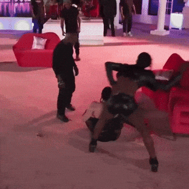 A Group Of People Are Dancing In A Room With Red Couch And Chairs GIF