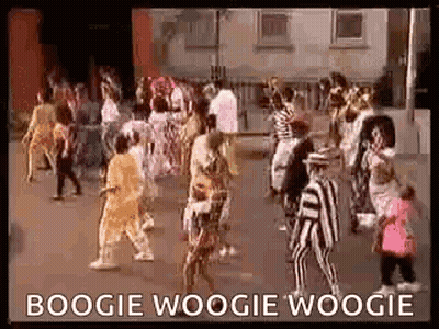 A Group Of People Are Dancing In A Street In Front Of A Building And A Sign That Says Boogie Woogie Woogie . GIF