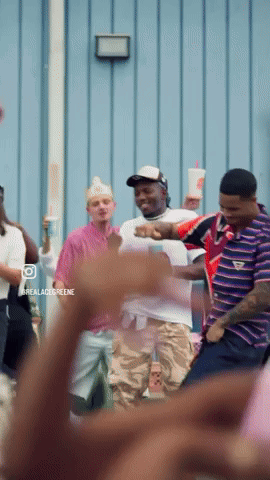 A Group Of People Are Dancing In Front Of A Blue Wall With The Words Realacidgreene On The Bottom GIF