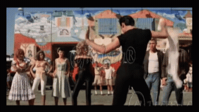 A Group Of People Are Dancing In Front Of A Building With A Mural On The Wall GIF