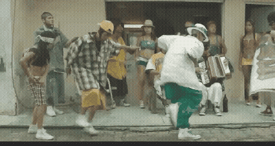 A Group Of People Are Dancing In Front Of A Building With A Sign That Says ' Aoc ' On It GIF