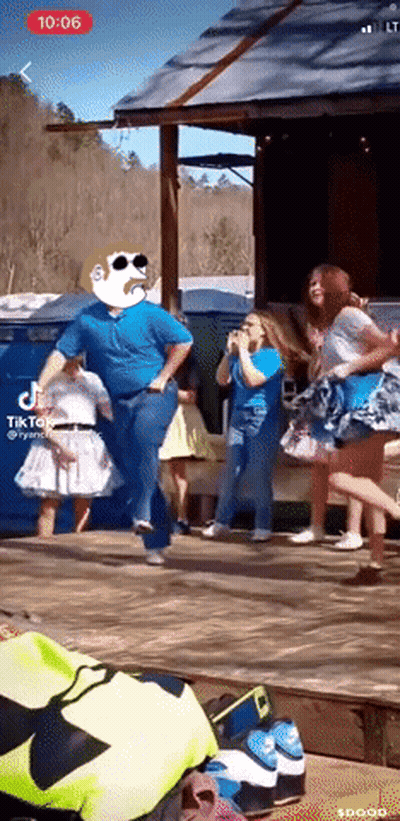 A Group Of People Are Dancing In Front Of A Building With Tik Tok Written On The Screen GIF