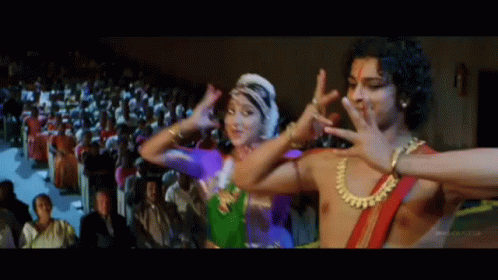 A Group Of People Are Dancing In Front Of A Crowd . GIF