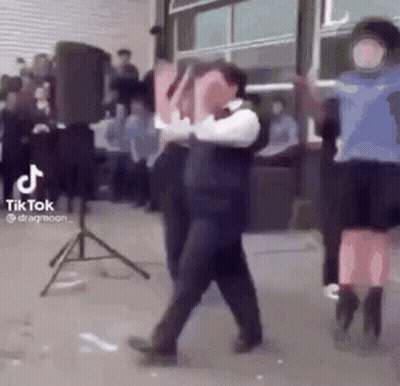 A Group Of People Are Dancing In Front Of A Crowd . GIF