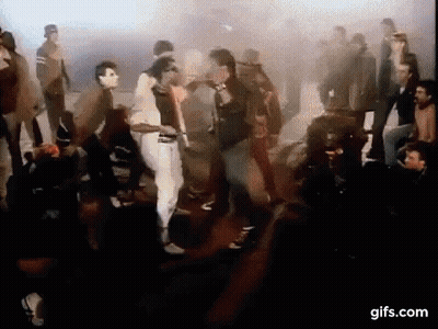 A Group Of People Are Dancing In Front Of A Crowd In A Club . GIF