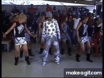 A Group Of People Are Dancing In Front Of A Crowd In A Club . GIF