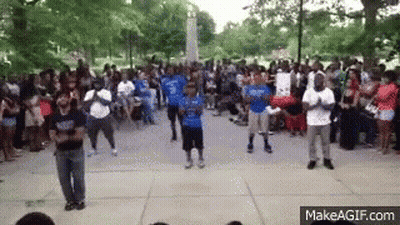 A Group Of People Are Dancing In Front Of A Crowd Of People . GIF