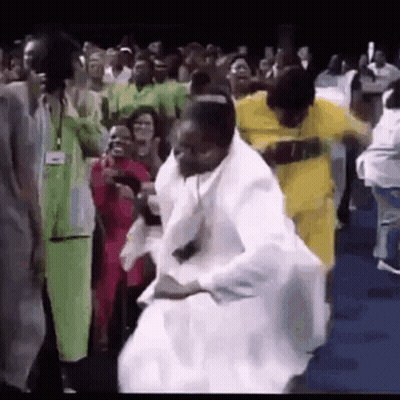 A Group Of People Are Dancing In Front Of A Crowd Of People . GIF