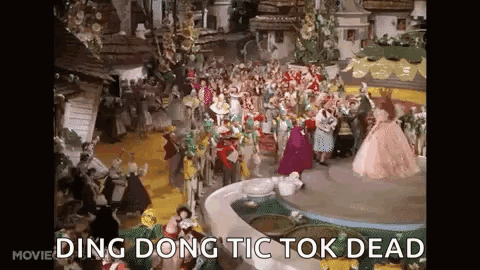 A Group Of People Are Dancing In Front Of A Fountain In A Wizard Of Oz Scene . GIF
