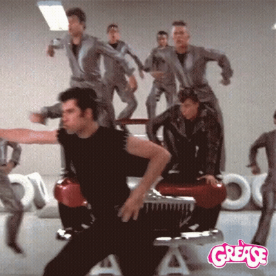 A Group Of People Are Dancing In Front Of A Grease Logo GIF