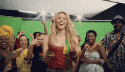 A Group Of People Are Dancing In Front Of A Green Screen And One Of Them Has The Letter M On Their Shirt GIF