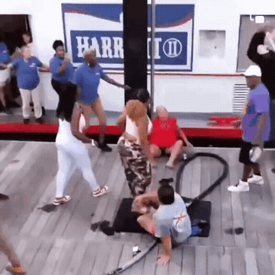 A Group Of People Are Dancing In Front Of A Harr Sign GIF