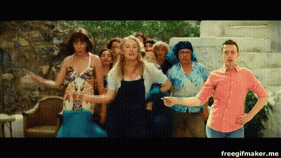 A Group Of People Are Dancing In Front Of A Man In A Red Shirt . GIF