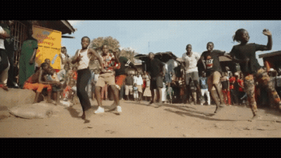 A Group Of People Are Dancing In Front Of A Mobile Money Store GIF