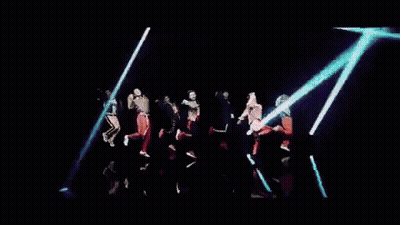 A Group Of People Are Dancing In Front Of A Neon Sign That Says Baby GIF
