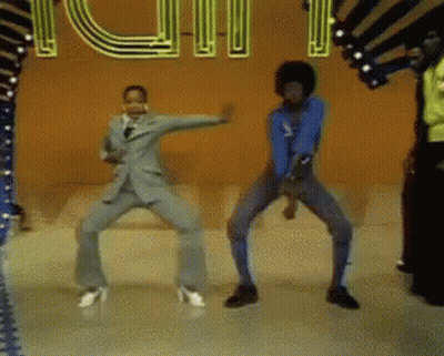 A Group Of People Are Dancing In Front Of A Neon Sign That Says Youth GIF
