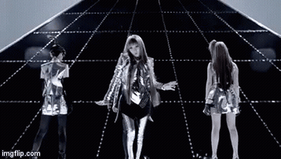 A Group Of People Are Dancing In Front Of A Pyramid On A Stage . GIF