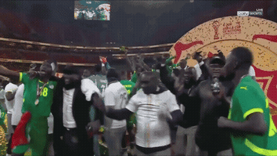 A Group Of People Are Dancing In Front Of A Screen That Says Sky Sports GIF