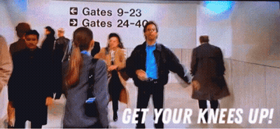 A Group Of People Are Dancing In Front Of A Sign That Says Gates 9-23 GIF