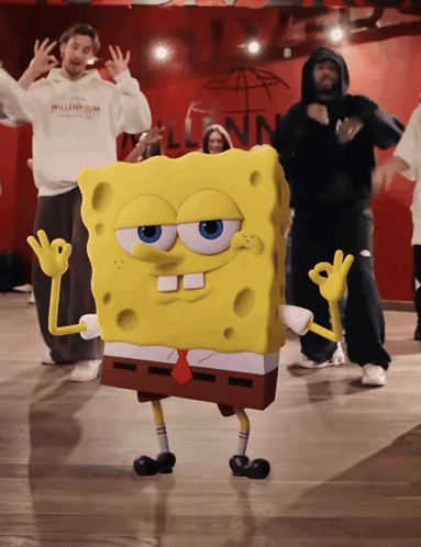 A Group Of People Are Dancing In Front Of A Sign That Says " Millennium " GIF