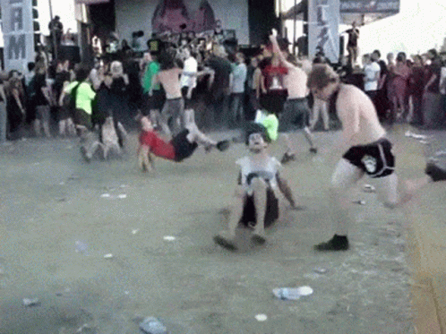 A Group Of People Are Dancing In Front Of A Sign That Says " Music " GIF