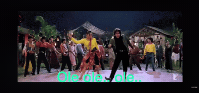 A Group Of People Are Dancing In Front Of A Sign That Says Ole Ole Ole .. GIF
