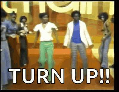 A Group Of People Are Dancing In Front Of A Sign That Says " Turn Up " GIF