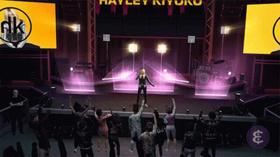 A Group Of People Are Dancing In Front Of A Stage That Says Harley Ryu On It GIF