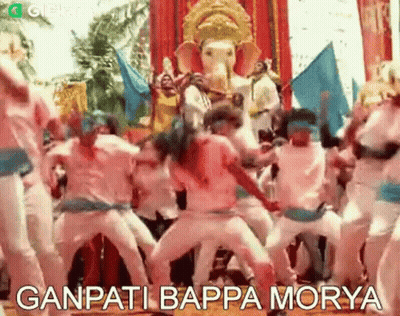 A Group Of People Are Dancing In Front Of A Statue Of Ganesha . GIF