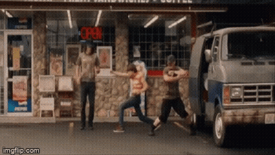A Group Of People Are Dancing In Front Of A Store With An Open Sign Above Them GIF