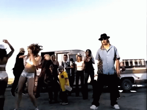 A Group Of People Are Dancing In Front Of A Truck That Says ' R.i.p. ' On The Back GIF