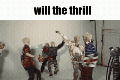 A Group Of People Are Dancing In Front Of A White Wall And The Words Will The Thrill Are Above Them GIF