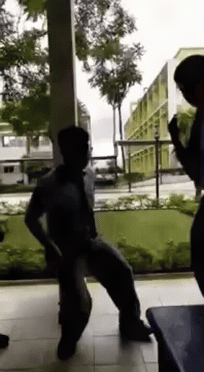 A Group Of People Are Dancing In Front Of A Window . GIF