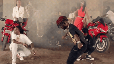 A Group Of People Are Dancing In Front Of Motorcycles And Smoke Coming Out Of Them GIF
