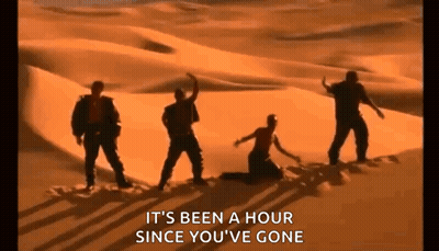 A Group Of People Are Dancing In The Desert While A Woman Is Kneeling Down . GIF